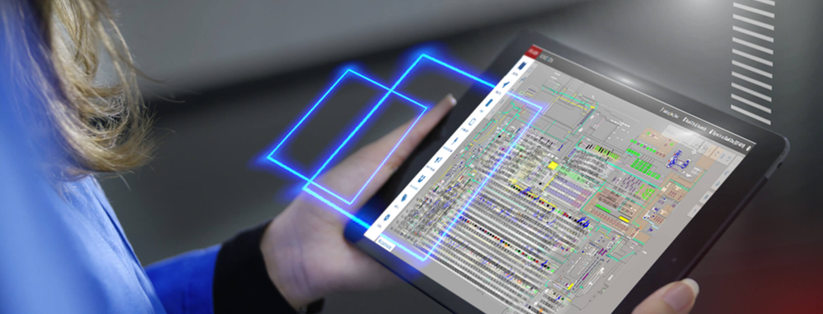 A person holding a tablet with the Kinexon OS application on it.