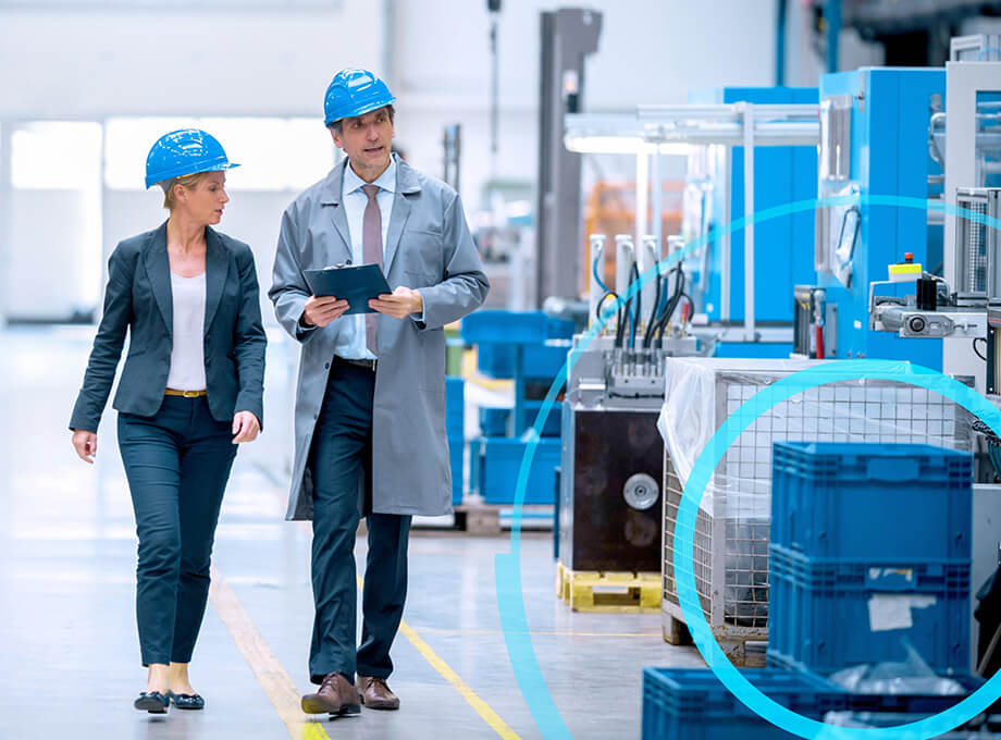 Two people in a smart factory with blue overlay.