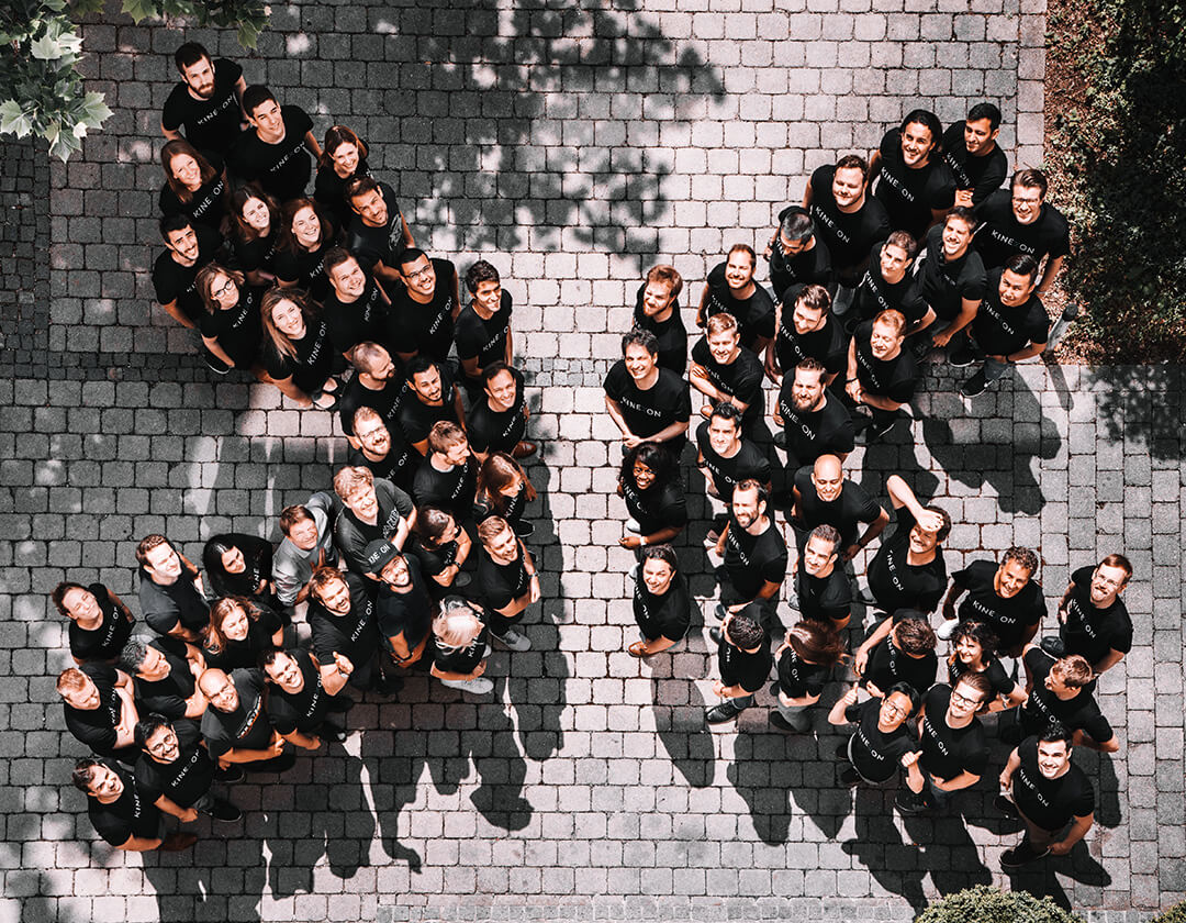 The Kinexon team forming an X photographed from above.