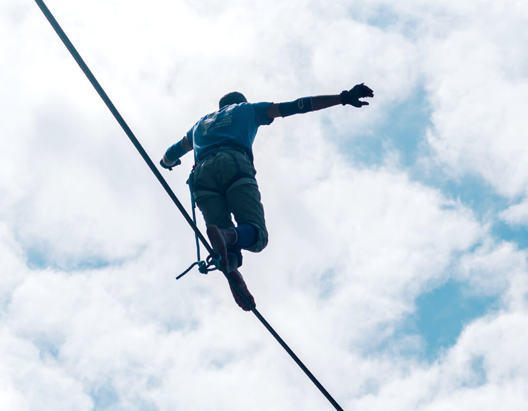 A person balancing on the tightrope.